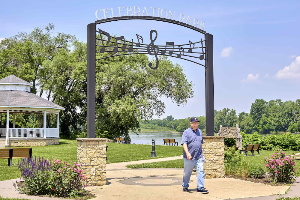 Total hip replacement patient of Dr Omar Akhtar walks in a park in Eastern Iowa