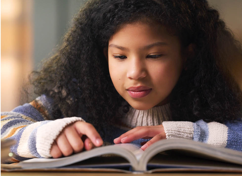 Girl reads book for summer reading program.